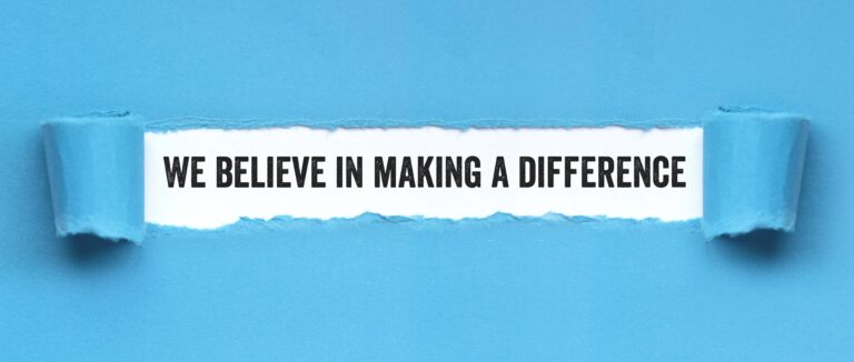 Blue paper ripped at the center revealing the words "We believe in making a difference"