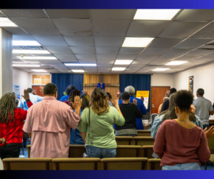Back of Church Showing Church Members with Hands Raised